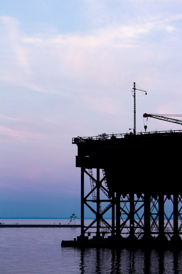 Industrial structure on the water at sunset