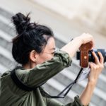 Woman taking a photo with a digital camera